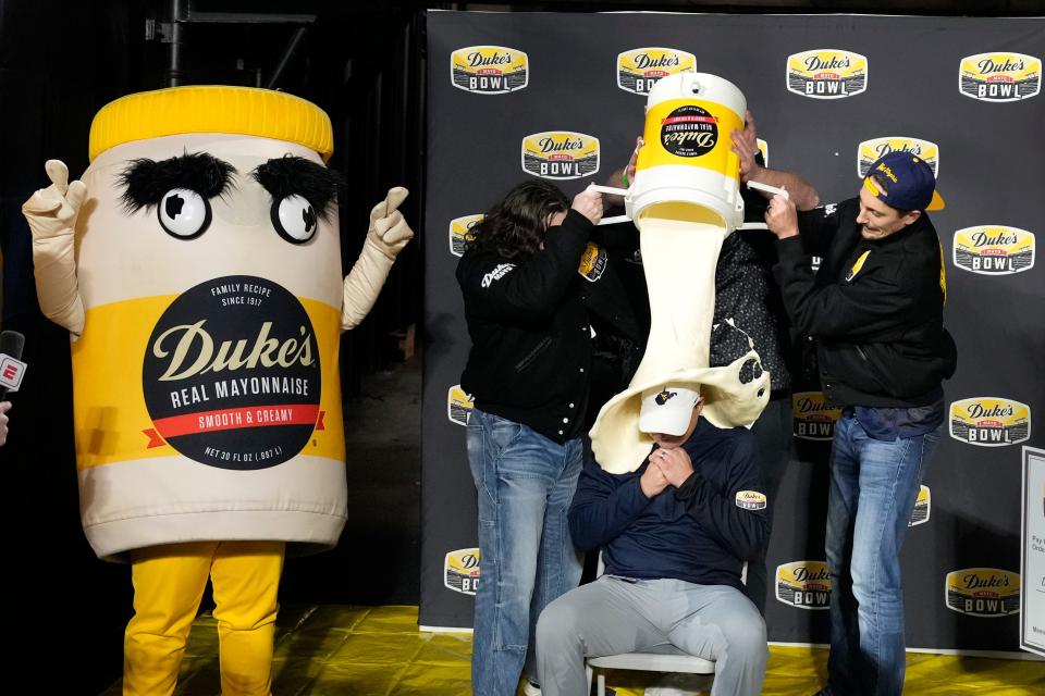 West Virginia head coach Neal Brown gets covered in mayonnaise after winning the Mayo Bowl over North Carolina at Bank of America Stadium in Charlotte, N.C.