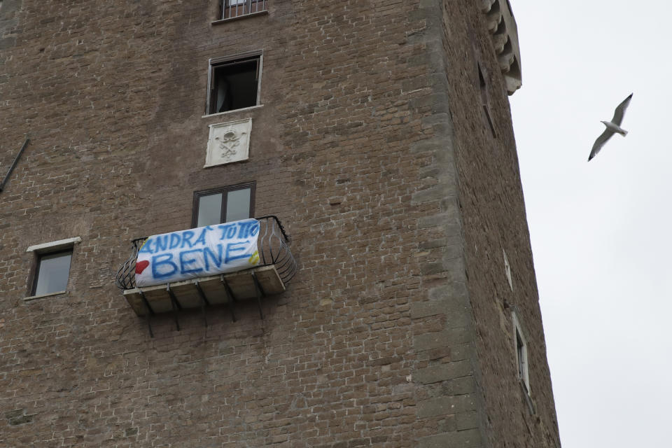 In this photo taken on Friday, March 13, 2020, a banner reading "Everything will be alright" hangs from Rome's Capitol Hill, Friday, March 13, 2020. The nationwide lockdown to slow coronavirus is still early days for much of Italy, but Italians are already are showing signs of solidarity. This week, children’s drawings of rainbows are appearing all over social media as well as on balconies and windows in major cities ready, ‘’Andra’ tutto bene,’’ Italian for ‘’Everything will be alright.’’ For most people, the new coronavirus causes only mild or moderate symptoms. For some, it can cause more severe illness, especially in older adults and people with existing health problems. (AP Photo/Alessandra Tarantino)