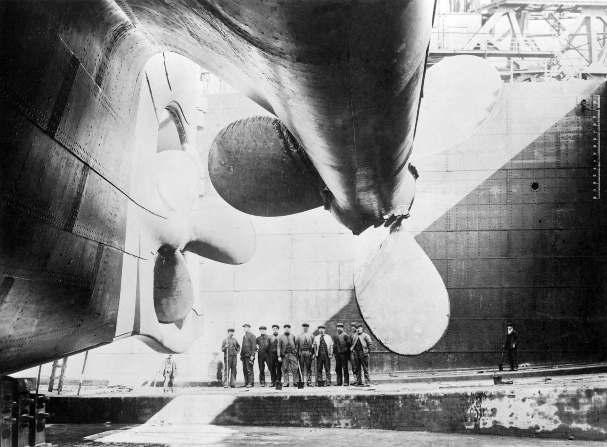 Image:Workmen stand under one of Titanic's propellers in 1911. (Heritage Images / Getty Images file)