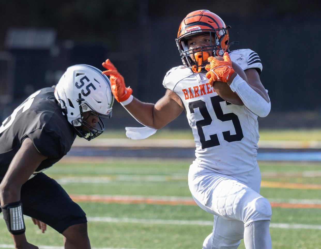 Barnegat Myquan Rush-Esdaile tries to turn the corner as East’s Terrance Thomas moves in for the tackle. Toms River East football beats Barnegat in season opener in Toms River on August 29, 2024.