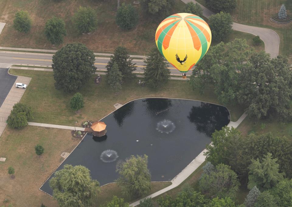 A balloon flies over Price Park in North Canton on Friday morning during the media/sponsor flight as part of the 2023 Balloon Classic.