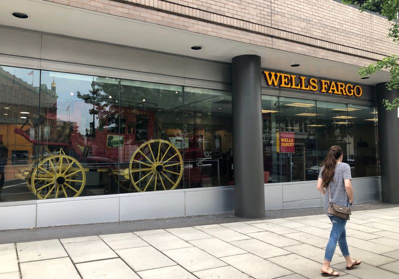 FILE PHOTO: A lady walks by a Wells Fargo bank branch in Washington