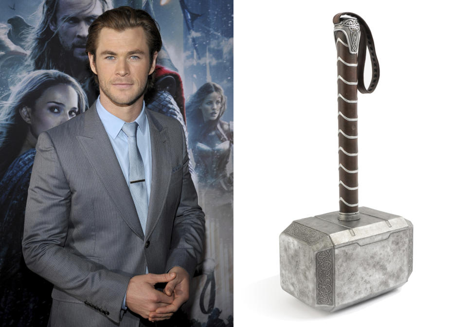 This combination photo shows actor Chris Hemsworth at the U.S. premiere of his film "Thor: The Dark World" in Los Angeles on Nov. 4, 2013, left, and a photo of the hammer from the film which will be going up for action July 15 through July 17 at Julien’s Auctions. (AP Photo, left, and Juliens Auctions via AP)