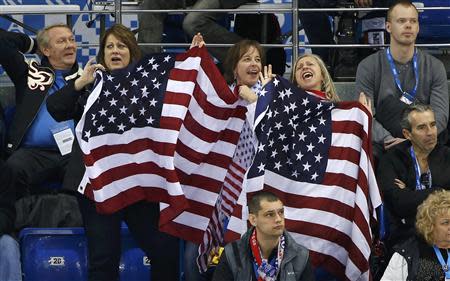 Team USA fans celebrate during the USA versus Slovakia men's preliminary round ice hockey game at the 2014 Sochi Winter Olympics, February 13, 2014. REUTERS/Jim Young