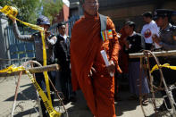 A Buddhist monk exits the Thai Embassy after delivering a statement during a protest in front of the Thai embassy in Yangon, Myanmar, against the Thai military government invoking a special emergency law to let authorities search the Dhammakaya Temple in an attempt to arrest a former abbot, February 24, 2017. REUTERS/Soe Zeya Tun