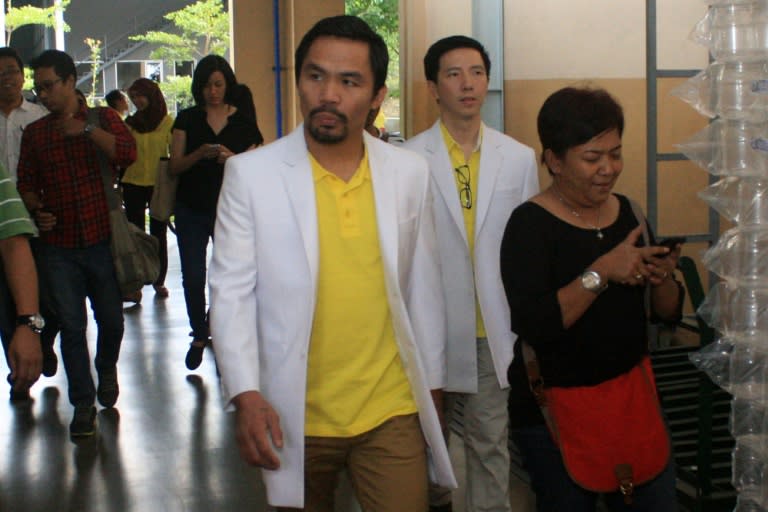 Filipino boxing champion Manny Pacquiao (C) visits a private Indonesian medicinal laboratory plant in Semarang, central Java island on July 8, 2015