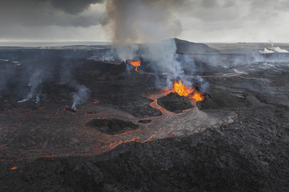 Panoramic view of the Svartsengi area with the active craters and lava flows in the foreground, near Grindavik, Iceland, Monday, June 3, 2024. The white steam in the top right is produced by the Powerplant and the Blue Lagoon area. (AP Photo/Marco di Marco)