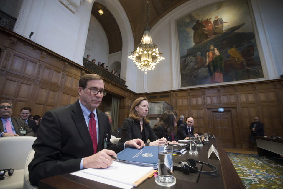 Richard Visek, left, agent of the U.S.A. and members of the U.S. delegation waits for judges to enter the International Court of Justice, or World Court, in The Hague, Netherlands, Wednesday, Feb. 13, 2019. The court is scheduled to deliver its judgement on U.S. objections about the court's jurisdiction in the case brought by the Islamic Republic of Iran. (AP Photo/Peter Dejong). (AP Photo/Peter Dejong)