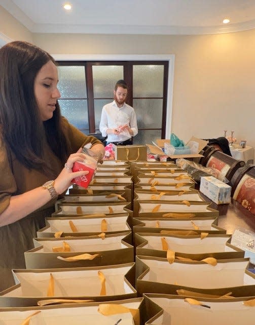 Members of the Chabad of the Space and Treasure Coasts prepare bags with traditional foods for Rosh Hashanah.