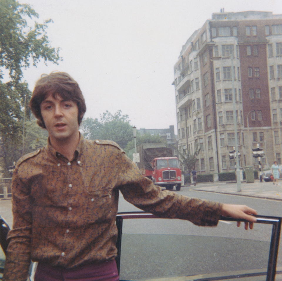 Portrait of Paul McCartney from The Beatles posed wearing a paisley shirt by a car door in a London street circa 1966.&nbsp;