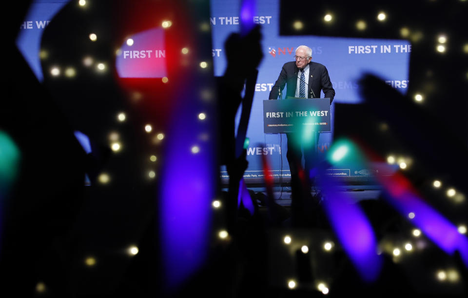 FILE - In this Sunday, Nov. 17, 2019 file photo, Democratic presidential candidate Sen. Bernie Sanders, I-Vt., speaks as supporters wave lighted signs during a fundraiser for the Nevada Democratic Party in Las Vegas. During the 2020 campaign, Sanders, who’s known more for eschewing organized religion than embracing his Jewishness, has shifted the way he talks about his faith and tied it to his broader worldview. (AP Photo/John Locher)