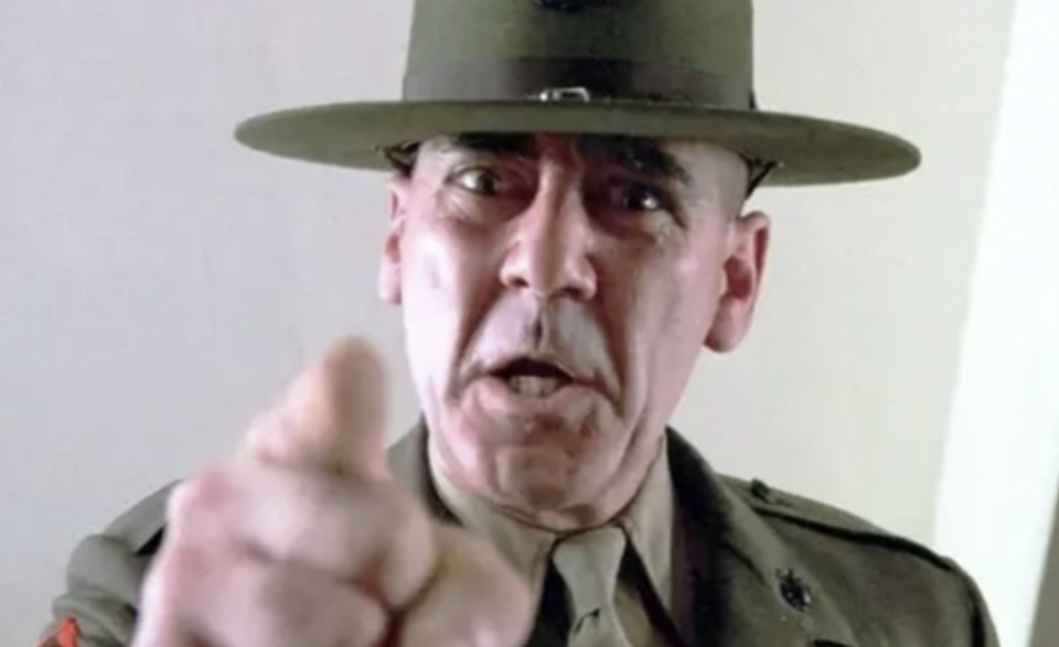 Ermey, in a marine uniforn angrily points at the camera