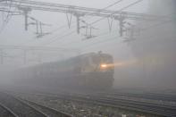 <p>A train passes in dense fog at a railway station in Amritsar on January 14, 2016. Fog and low temperatures are common during the winter months in northern India. </p>