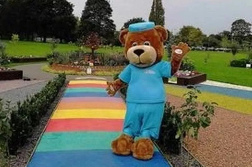 Scrubs the bear ready to welcome participants in the Buggy Buddies walk, starting from the Rainbow Baby Garden
