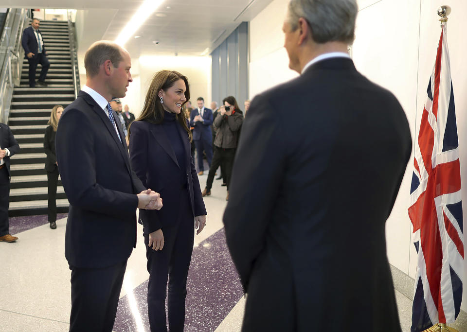 Britain's Prince William and Kate, Princess of Wales, are greeted by Massachusetts Gov. Charlie Baker, right, as they arrive at Boston Logan International Airport, Wednesday, Nov. 30, 2022, in Boston. The Prince and Princess of Wales are making their first overseas trip since the death of Queen Elizabeth II in September. (John Tlumacki/The Boston Globe via AP, Pool)