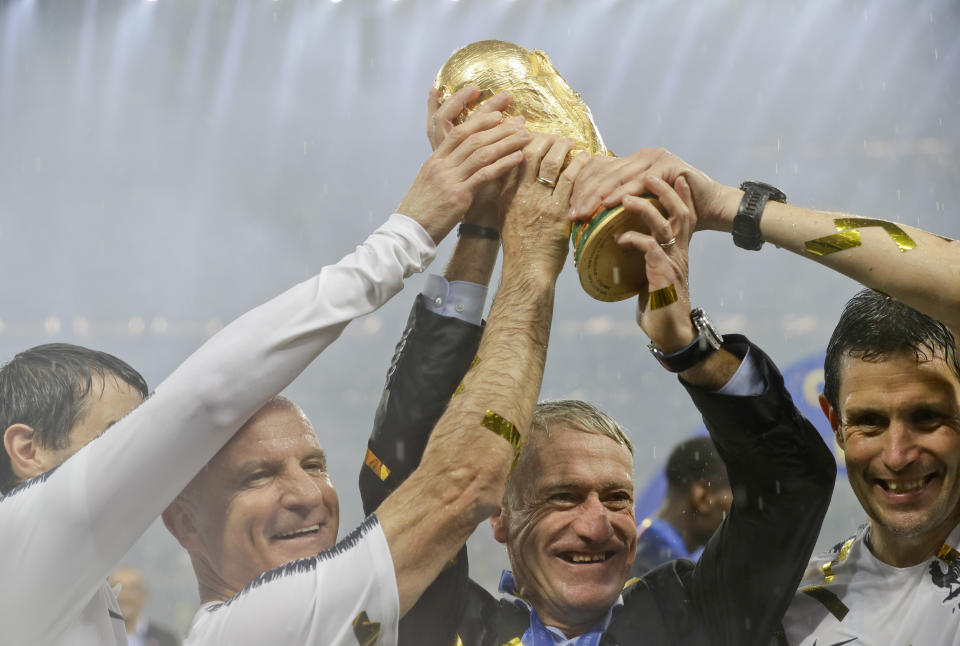 FILE - In this Sunday, July 15, 2018 file photo, France head coach Didier Deschamps, second right, holds the trophy at the end of the final match between France and Croatia at the 2018 soccer World Cup in the Luzhniki Stadium in Moscow, Russia. (AP Photo/Matthias Schrader, File)