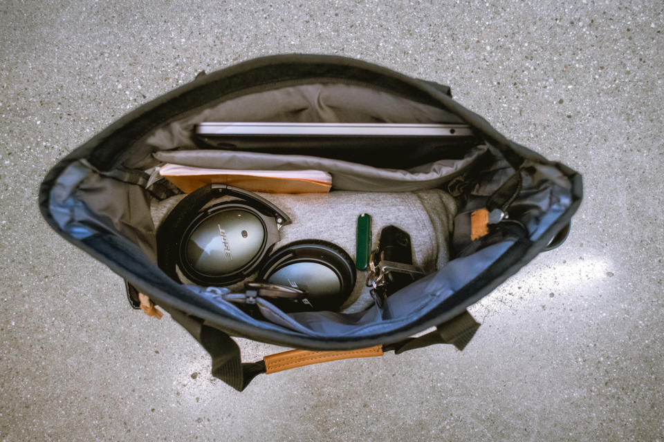 interior of Eddie Bauer tote bag with headphones, notebooks and a laptop