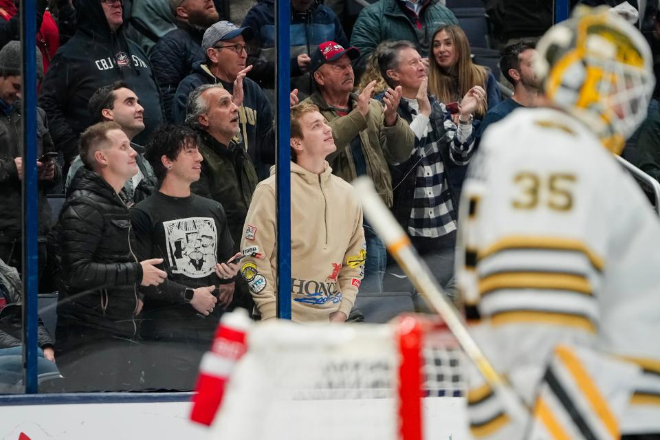 Nov 27, 2023; Columbus, Ohio, USA; Josh Dun, second from left, of the band Twenty One Pilots watches from the front row behind Boston Bruins goaltender Linus Ullmark (35) during the third period of the NHL game against the Columbus Blue Jackets at Nationwide Arena. The Blue Jackets won 5-2.