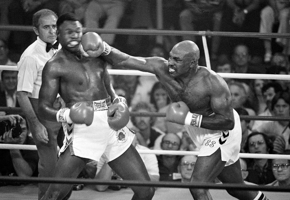 Larry Holmes went down but not out in his title defense against Earnie Shavers (right), who packed boxing's biggest punch throughout the 1970s.