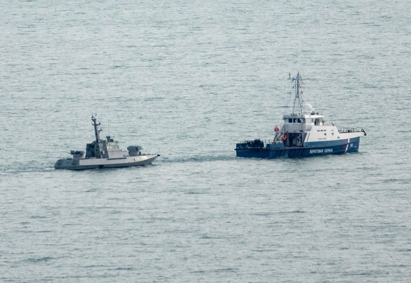 Seized Ukrainian naval ships are towed by Russia's Coast Guard vessels out of the port in Kerch