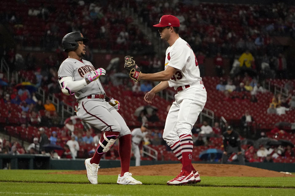 Arizona Diamondbacks' Ketel Marte, left, grounds out to St. Louis Cardinals starting pitcher Dakota Hudson during the fifth inning of a baseball game Thursday, April 28, 2022, in St. Louis. (AP Photo/Jeff Roberson)