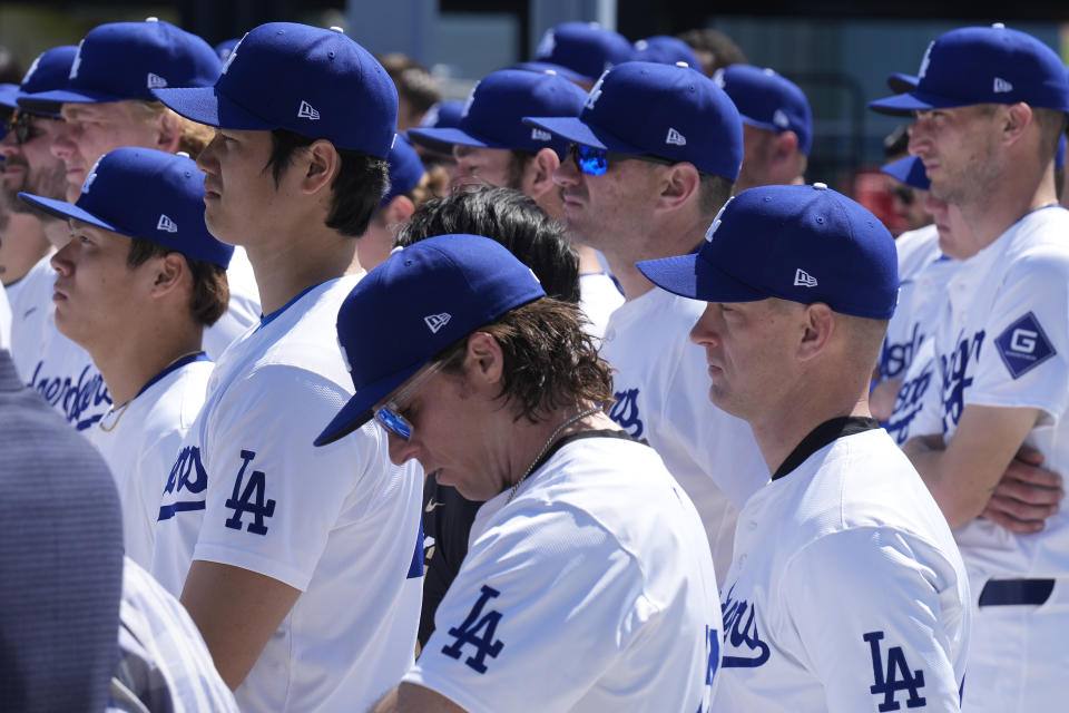 Los Angeles Dodgers pitchers Shohei Ohtani, left, celebrates Jackie Robinson Day alongside teammates before a baseball game against the Washington Nationals at Dodgers Stadium in Los Angeles on Monday, April 15, 2024. (AP Photo/Damian Dovarganes)