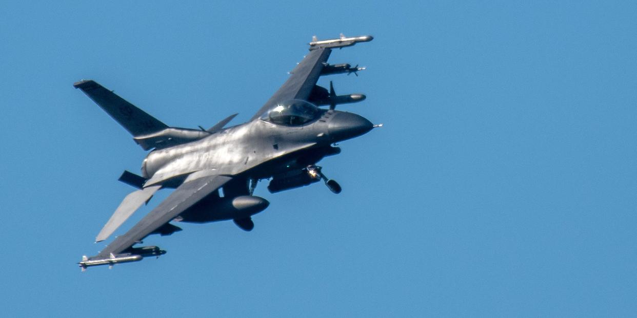 An F-16 jet with its landing gear extended to land at the U.S. military airfield at Spangdahlem, Germany.