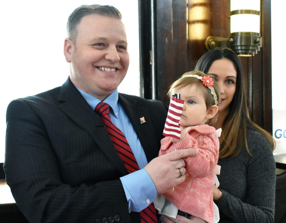 David Gordon and his fiancee Deanna Diardo stand with their daughter Geneieve on Thursday following his campaign announcement.