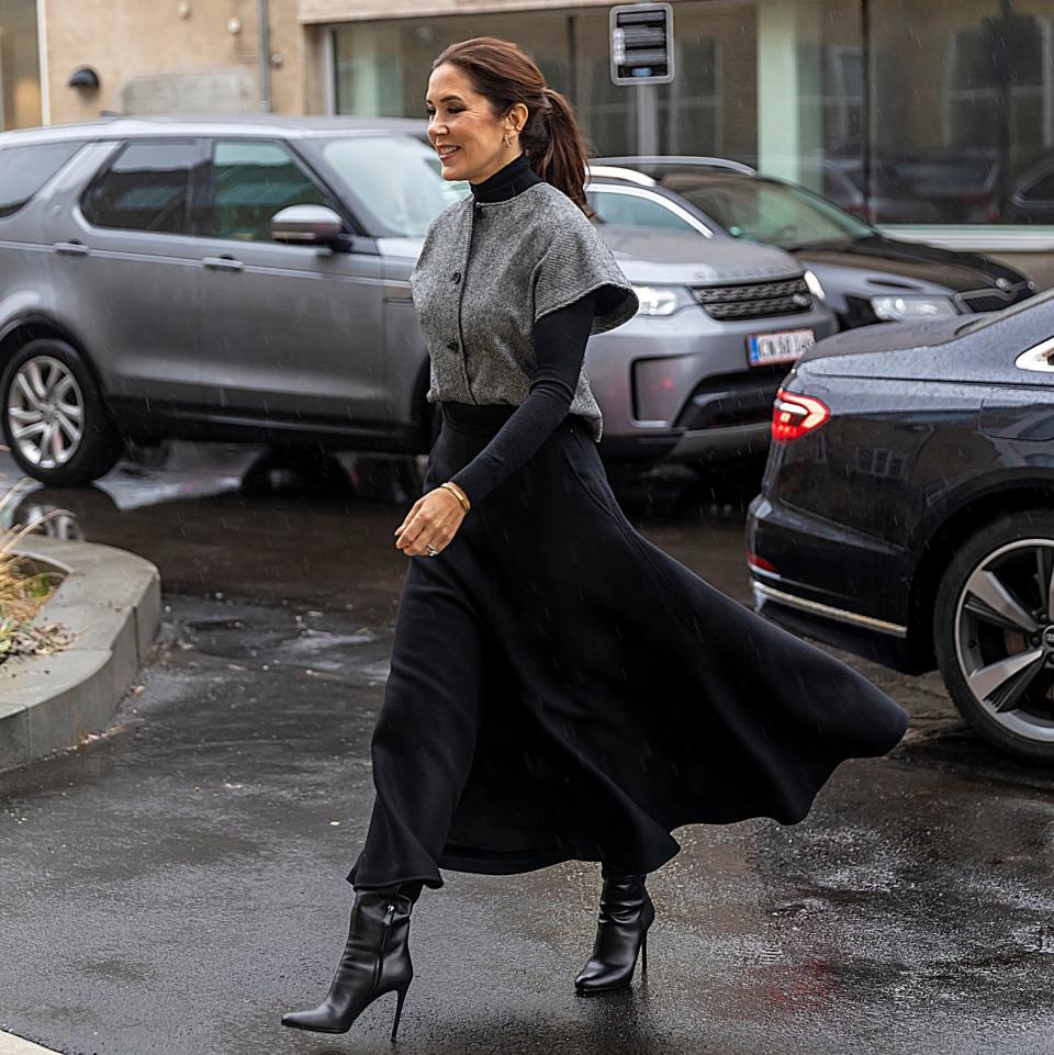 Crown Princess Mary of Denmark wears a black polo shirt under her vest