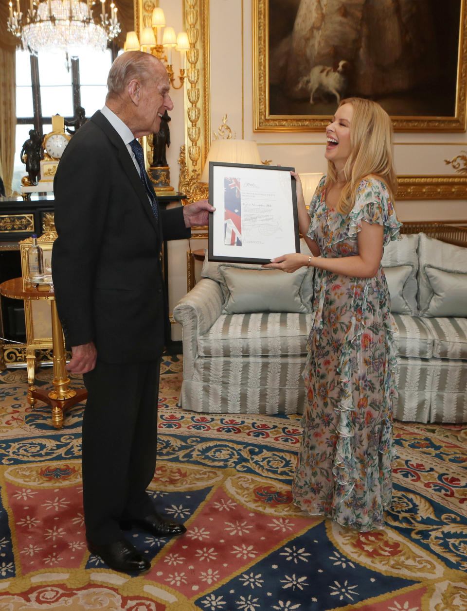 Prince Philip laughs as he presents Kylie Minogue with the Britain-Australia Society Award for 2016 