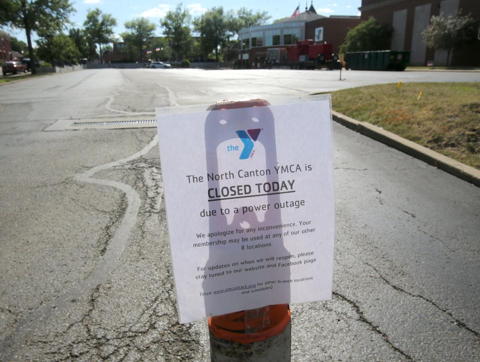 A sign indicates the North Canton YMCA will be closed on Monday, June 27, 2022. Events were moved outside after "a considerable pool leak" caused extensive water damage in the basement.