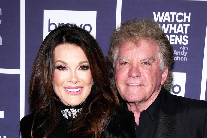 Lisa Vanderpump and Ken Todd pose in front of a step and repeat at Watch What Happens Live.