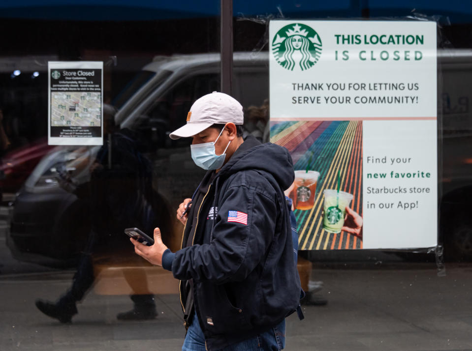 NEW YORK, NEW YORK - OCTOBER 28: A person walks by a permanently closed Starbucks location as the city continues the re-opening efforts following restrictions imposed to slow the spread of coronavirus on October 28, 2020 in New York City. The pandemic continues to burden restaurants and bars as businesses struggle to thrive with evolving government restrictions and social distancing plans which impact keeping businesses open yet challenge profitability. (Photo by Noam Galai/Getty Images)