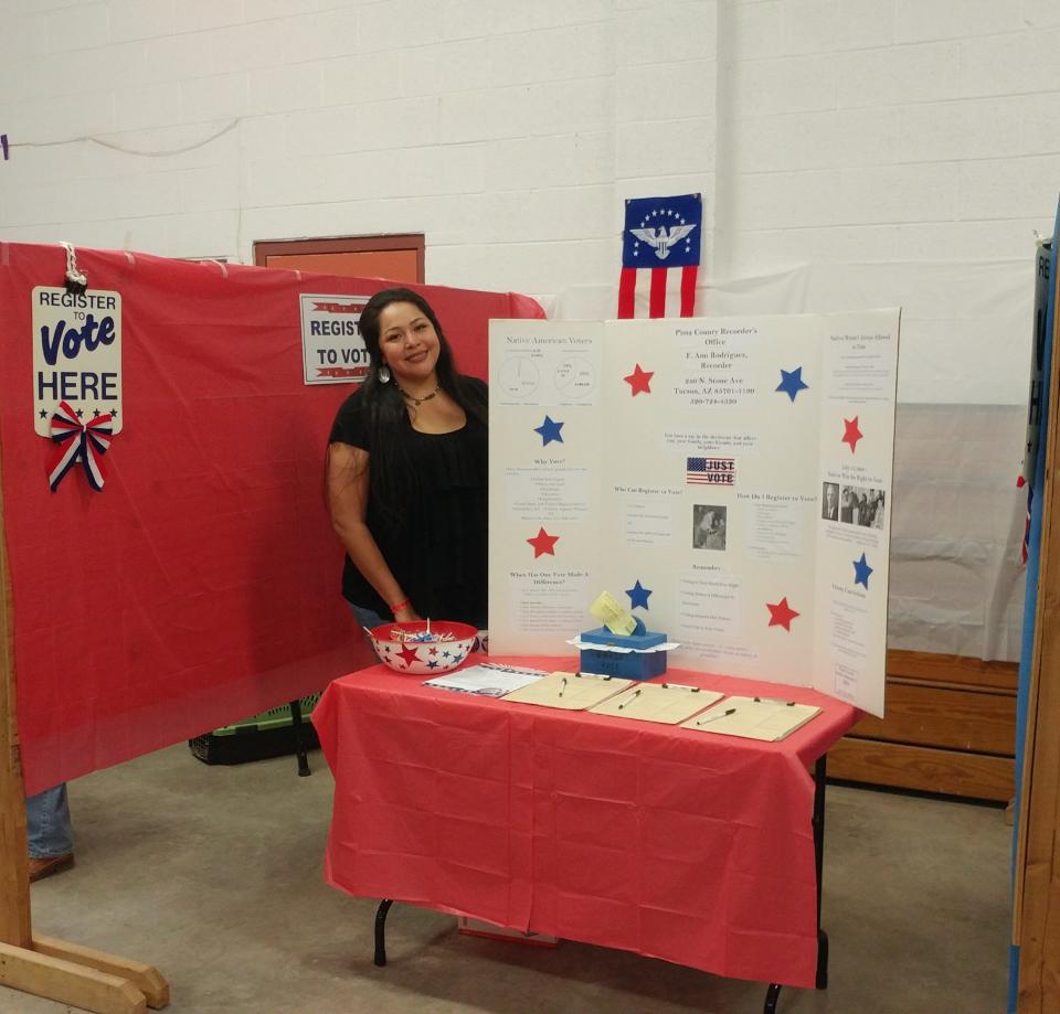 Tohono O’odham outreach coordinator Stephanie Homewytewa stood next to a poster board Jan. 30, 2020 explaining the history of the Native Vote in Arizona. The voter registration event was held at the Tohono O’odham Rodeo. (Photo courtesy of the Pima County Recorder's Office)