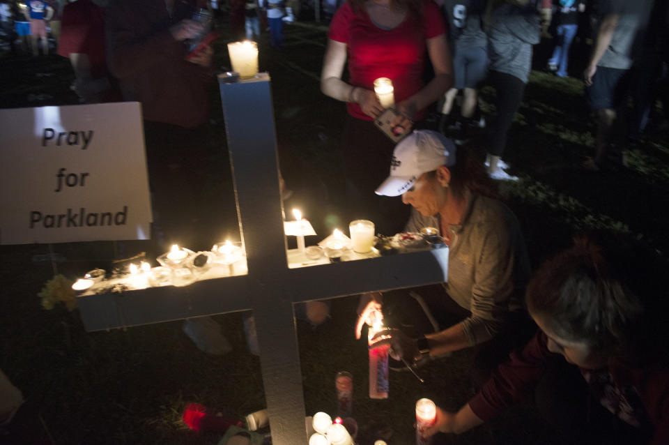 A cross adorned with lit candles was one of many seen at Thursday night's vigil.