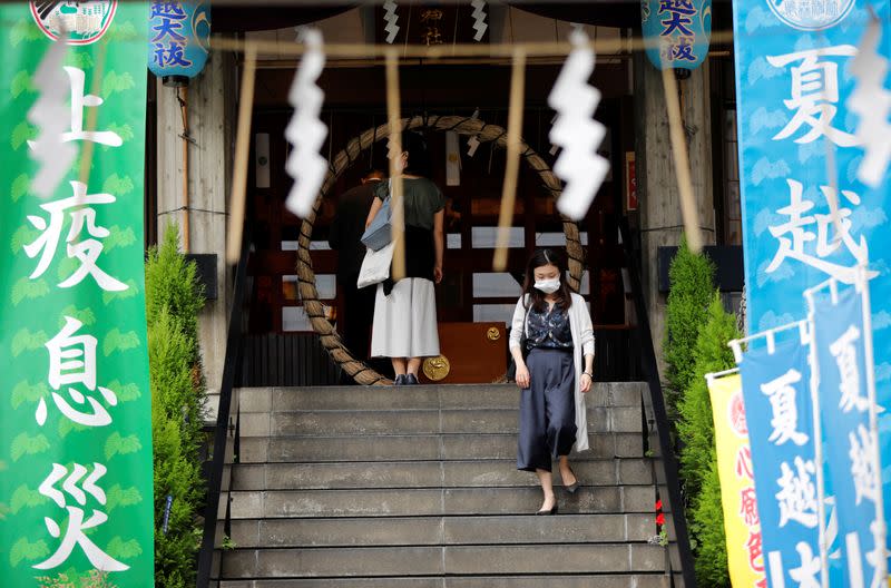 A visitor wearing a protective face mask is seen at a shrine amid the coronavirus disease (COVID-19) outbreak, in Tokyo