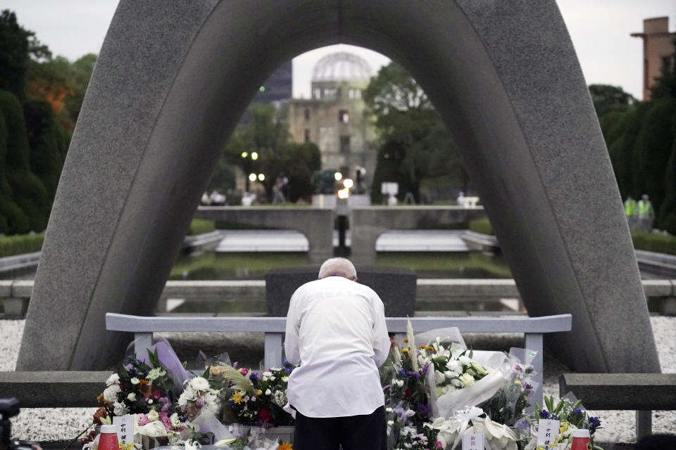 A man prays in front of the cenotaph for the atomic bombing victims before the start of ceremony to mark the 75th anniversary of the bombing in Hiroshima, western Japan, early Thursday, Aug. 6, 2020. (AP Photo/Eugene Hoshiko)