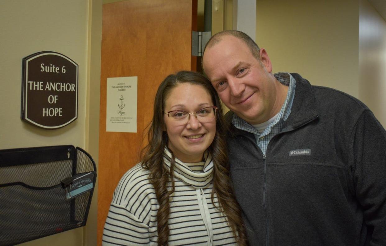 Pastor James Pitt was praying about serving teens when he felt God talk to him about starting a church in Ottawa County. Here, he stands with his wife, Amber Pitt, inside the Sutton Center, where they have their church, the Anchor of Hope Church.