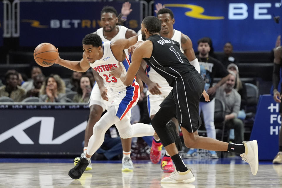 Detroit Pistons guard Jaden Ivey (23) brings the ball up court as Brooklyn Nets forward Mikal Bridges (1) defends during the second half of an NBA basketball game, Thursday, March 7, 2024, in Detroit. (AP Photo/Carlos Osorio)
