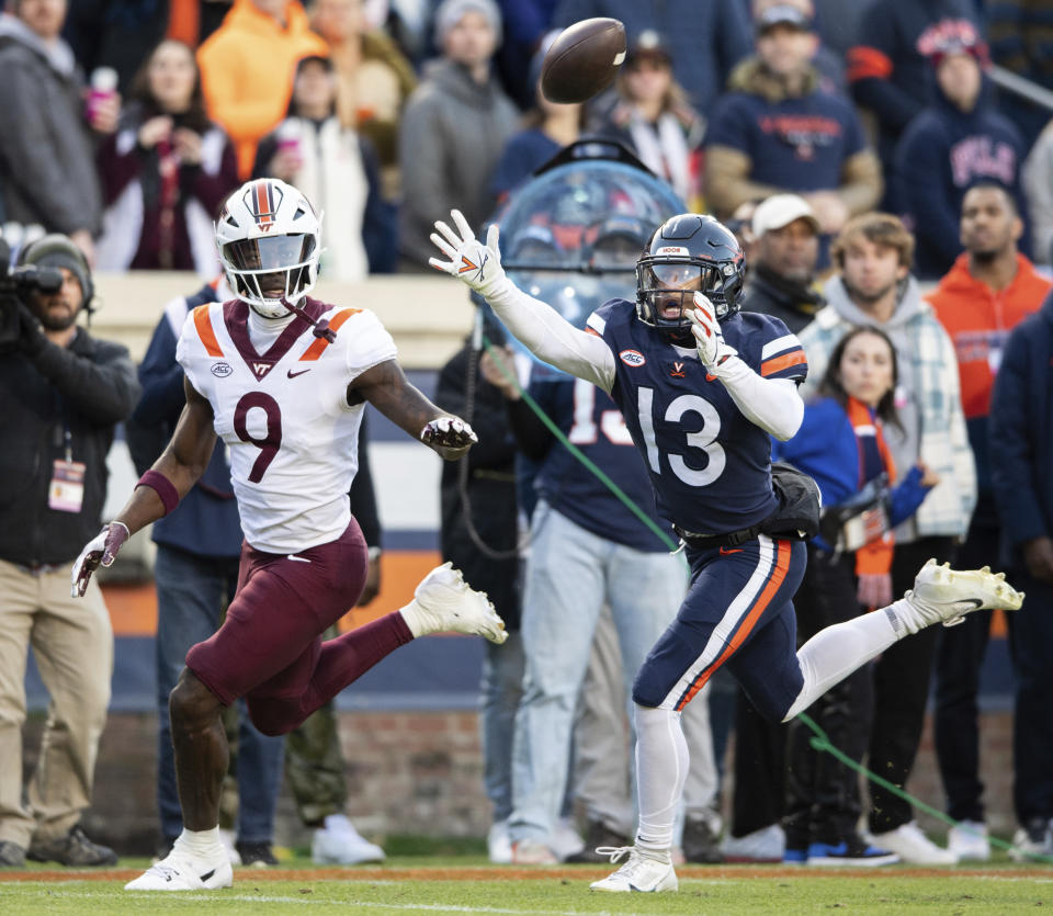 Virginia cornerback Sam Westfall (13) breaks up a pass intended for Virginia Tech wide receiver Da'Quan Felton (9) during the first half of an NCAA college football game Saturday, Nov. 25, 2023, in Charlottesville, Va. (AP Photo/Mike Caudill)