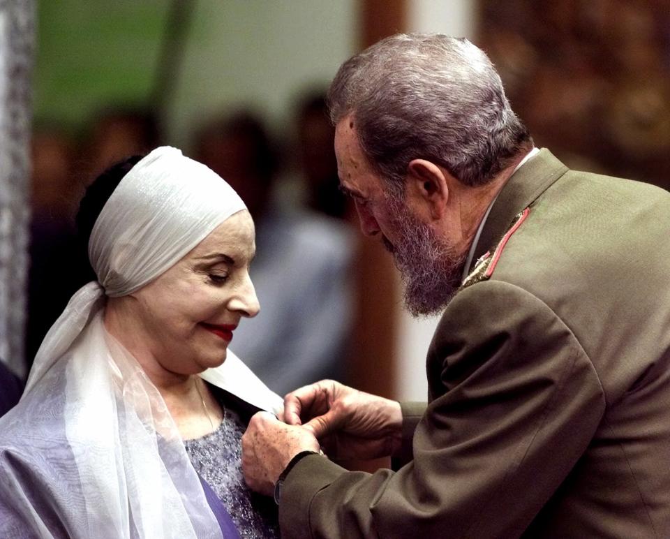 Alicia Alonso, Cuba's grande dame of dance and the founder of the internationally renowned National Ballet of Cuba, receives the Jose Marti medal, Cuba's highest honor, from Cuban leader Fidel Castro Wednesday, Dec. 20, 2000, at the Revolution Palace in Havana. (AP Photo/Jose Goitia)