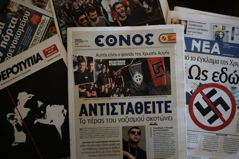 A front-page picture in centre-left daily Ethnos (centre), shows the self-confessed killer of a Greek musician at a Golden Dawn summer camp, on September 19, 2013. Greek Prime Minister Antonis Samaras on Thursday said he would not allow neo-Nazi party Golden Dawn to "undermine" democracy after one of its alleged supporters fatally stabbed a popular anti-fascist musician