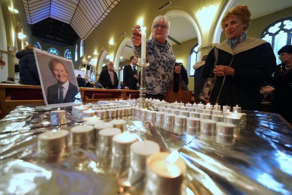 People light candles during a vigil at St Michael’s & All Angels church in Leigh-on-Sea in Essex for Conservative MP Sir David Amess (Kirsty O’Connor/PA) (PA Wire)