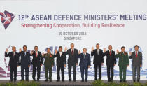 Defense Ministers from left to right, Brunei's Second Minister, Brunei, Halbi Nin Haji Mohd Yusof, Cambodia's Samdech Pichey Sena Tea Banh, Indonesia's General Ryamizard Ryacudu, Laos' Lieutenant-General Chansamone Chanyalath, Malaysia's Haji Mohamad Bin Sabu, Singapore's Ng Eng Hen, Thai General Prawit Wongsuwon, Myanmar's Lieutenant-General Sein Win, Philippines' Delfin N. Lorenzana, Vietnam's General Ngo Xuan Lich and ASEAN Deputy Secretary General Hoang Anh Tuan during a group photo for the ASEAN Defense Ministers' Meeting in Singapore Friday, Oct. 19, 2018. (AP Photo/Don Wong)