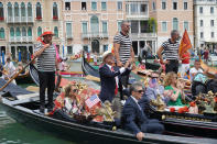 The U.S. ambassador to Italy, Lewis Eisenberg, applauds as he stands on a gondola during the Vogada della Rinascita (Rowing of Rebirth) regatta, along Venice canals, Italy, Sunday, June 21, 2020. The regatta was an initiative to pay homage to the medical staff and their hard work and contribution during the COVID-19 pandemic. (Anteo Marinoni/LaPresse via AP)