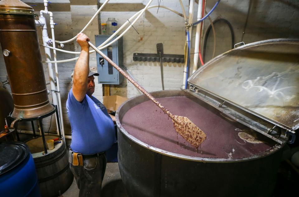 James Sampson, distiller at Bluegrass Distillers, turns the mash while working at the small distillery in Lexington.  