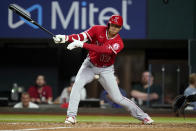 Los Angeles Angels' Shohei Ohtani is hit on the groin by the ball he fouled off, on a pitch thrown by Texas Rangers reliever Brett Martin during the seventh inning of a baseball game Tuesday, May 17, 2022, in Arlington, Texas. (AP Photo/Tony Gutierrez)