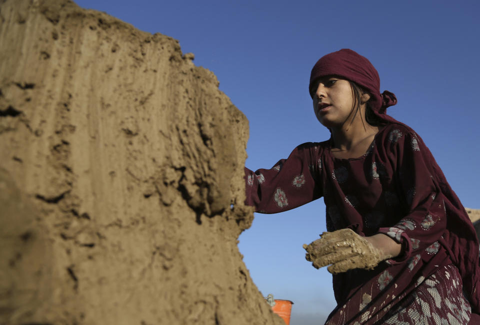In this Wednesday, June 19, 2019, photo, Hameda, 8, works at a brick factory on the outskirts of Kabul, Afghanistan. The U.S. and its allies have sunk billions of dollars of aid into Afghanistan since the invasion to oust the Taliban 18 years ago, but the country remains mired in poverty. Signs of hardship are everywhere, from children begging in the streets to entire families _ including children as young as five or six _ working at brick kilns in the sweltering heat.(AP Photo/Rahmat Gul)