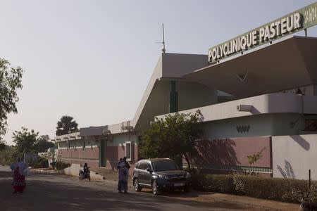 Quarantined patients are seen outside the locked down Pasteur Clinic in Bamako November 12, 2014. REUTERS/Joe Penney