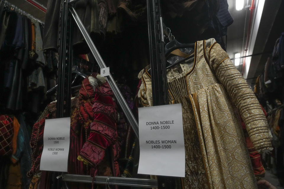 Dresses hang at the Tirelli's warehouse in Formello near Rome, Tuesday, March 5, 2024. For nearly six decades, the Tirelli atelier in Rome has woven itself into the fabric of Italian and international film history, earning the nickname the "Oscar tailor's shop" for its contribution to cinematic costume design. Established in November 1964, the shop on a quiet Roman street has been behind 17 Academy Awards for Best Costume Design. (AP Photo/Gregorio Borgia)